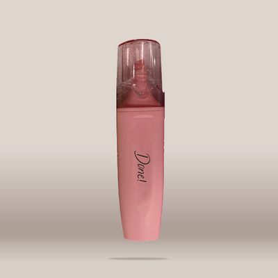 A pink cosmetic tube with a clear cap, featuring the brand name 'Done!' printed in black script on the front, set against a neutral beige background.