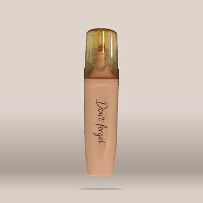 A single bottle of liquid foundation or concealer with a translucent cap, shown centered on a plain light gray background. The bottle is a warm nude beige shade with the words 'Don't forget' printed vertically in black script near the lower half.