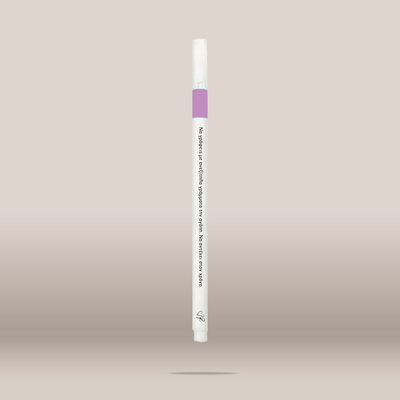 A single white cosmetic pen-style applicator with a light purple band near the top, shown centered against a soft beige gradient background.