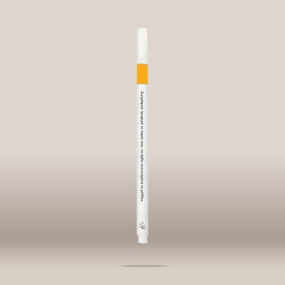A single white cosmetic pen or applicator with a bright orange band near the top, shown vertically against a soft beige gradient background. Small black text is printed on the barrel, and a small logo appears near the bottom.