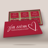 A red gift box set with multiple small red cards or envelopes arranged inside an open tray, plus a larger front cover placed in front. The packaging has white script text and a white heart outline, photographed on a clean light beige background.