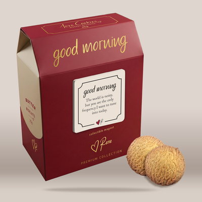 A red and beige gift box of Jore Cookies with gold foil lettering, shown next to two textured golden-brown cookies on a neutral beige background.