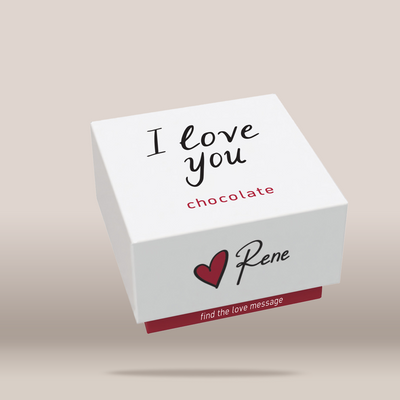 A white square gift box with printed messages, including 'I love you chocolate' and 'find the love message', shown floating against a light beige background.