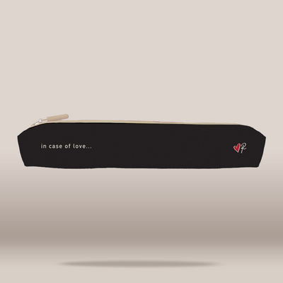 A black zippered pencil case with a cream zipper pull, featuring the white text 'in case of love.