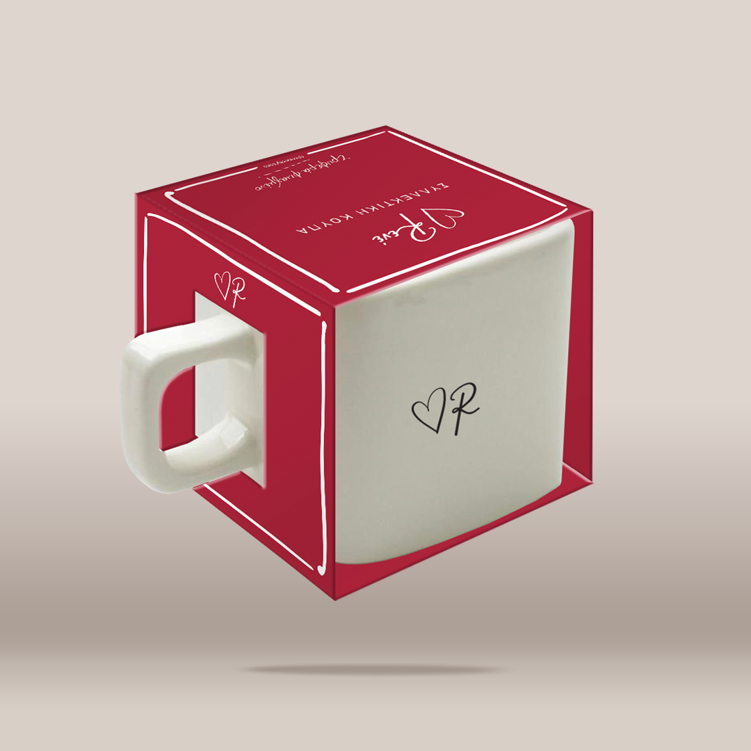 A white ceramic mug with a red cube-shaped packaging box featuring white line details and a handle cutout, shown on a neutral beige background.