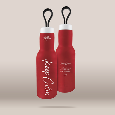 Two red insulated water bottles with black loop handles and white caps, shown on a plain beige background. One bottle is front-facing with large white script text reading 'Keep Calm' and smaller text below, and the other is angled behind it showing additional white text and a small heart logo with 'Pean'.