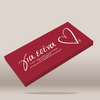 A rectangular red box with white cursive Greek text and a white outlined heart, shown floating at an angle on a light beige background.