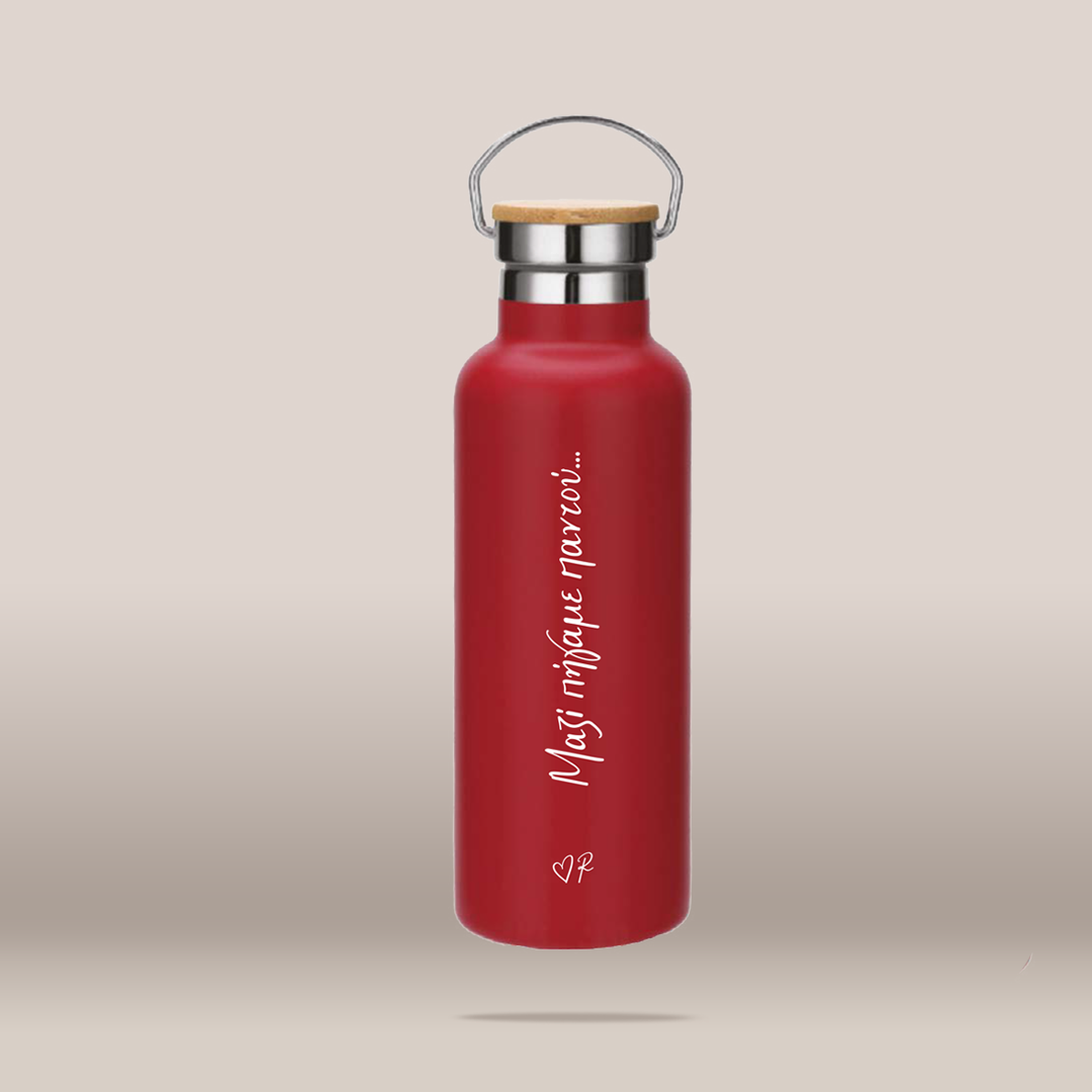 A matte red insulated water bottle with a bamboo lid and stainless steel carrying loop, featuring white vertical text reading 'Μαζί πήγαμε παντού'.