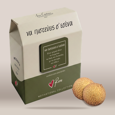 A milk carton-style box of cookies with Greek text, shown on a plain light beige background with two round textured cookies placed in front. The box is cream and olive green with a dark green label panel and the visible brand name Rene.