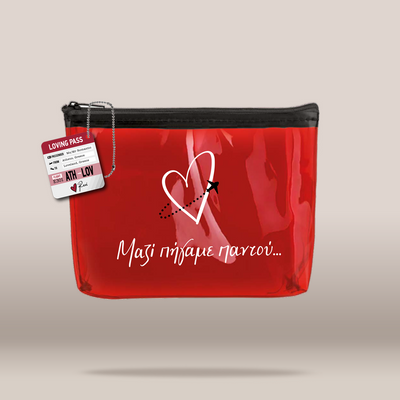 A glossy red zippered pouch with a black zipper, featuring a white heart outline, a small black star, and the Greek phrase 'Μαζί πήγαμε παντού'.