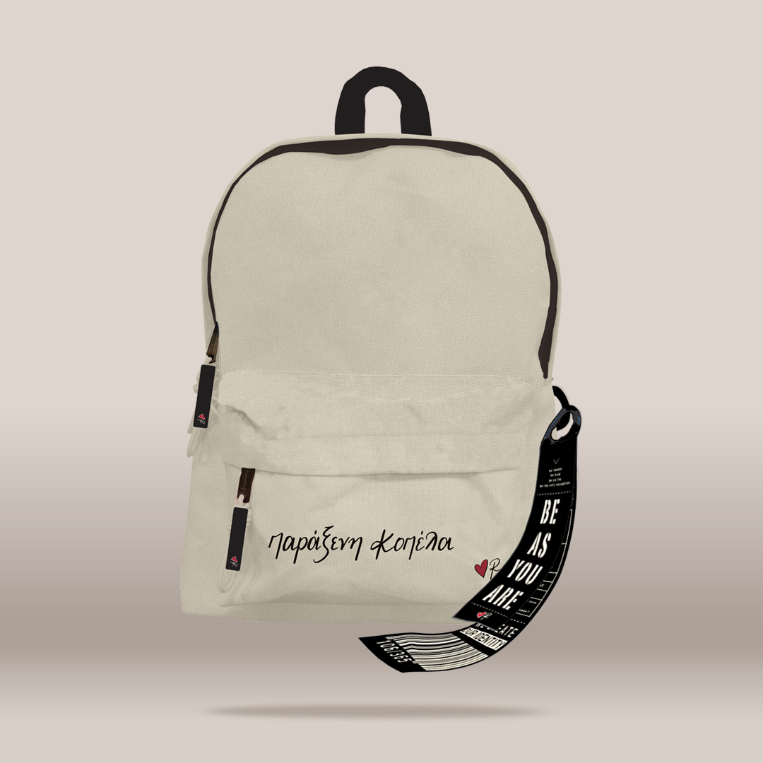 An off-white canvas backpack with black trim, featuring a front zippered pocket with the text  in black script, and a black hanging strap with the text 'BE AS YOU ARE'.