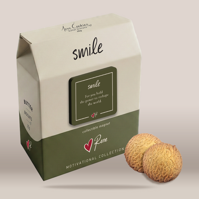A milk carton-style product box labeled 'smile' with a collectible magnet, shown beside two round textured cookies on a plain light beige background.