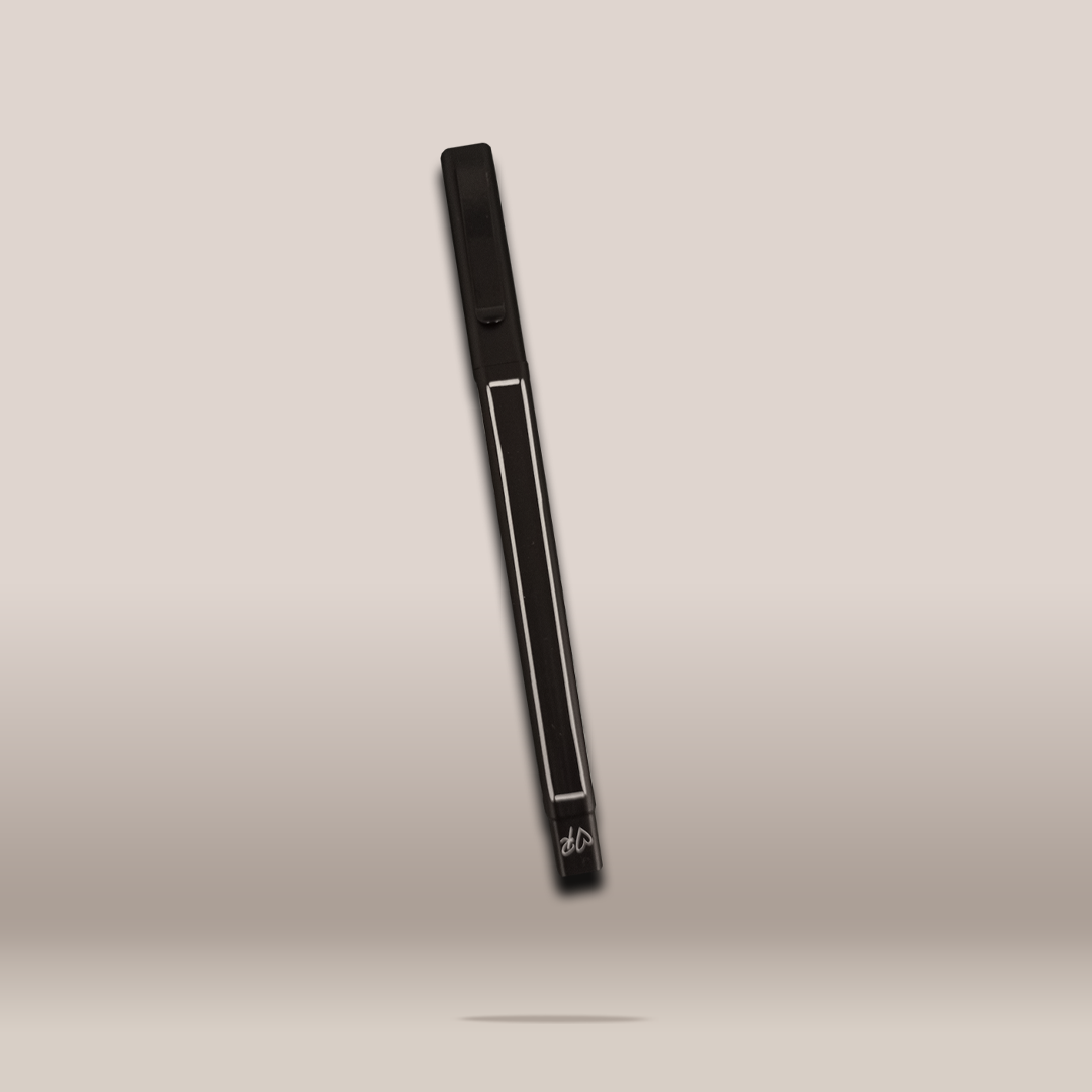 A slim black rectangular accessory with a white rectangular outline and small white script near the bottom, shown floating against a soft beige gradient background.